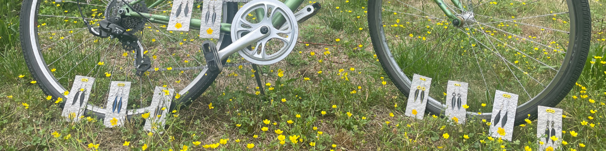 Bike with BikeBloom upcycled bike tube earrings on plantable packaging